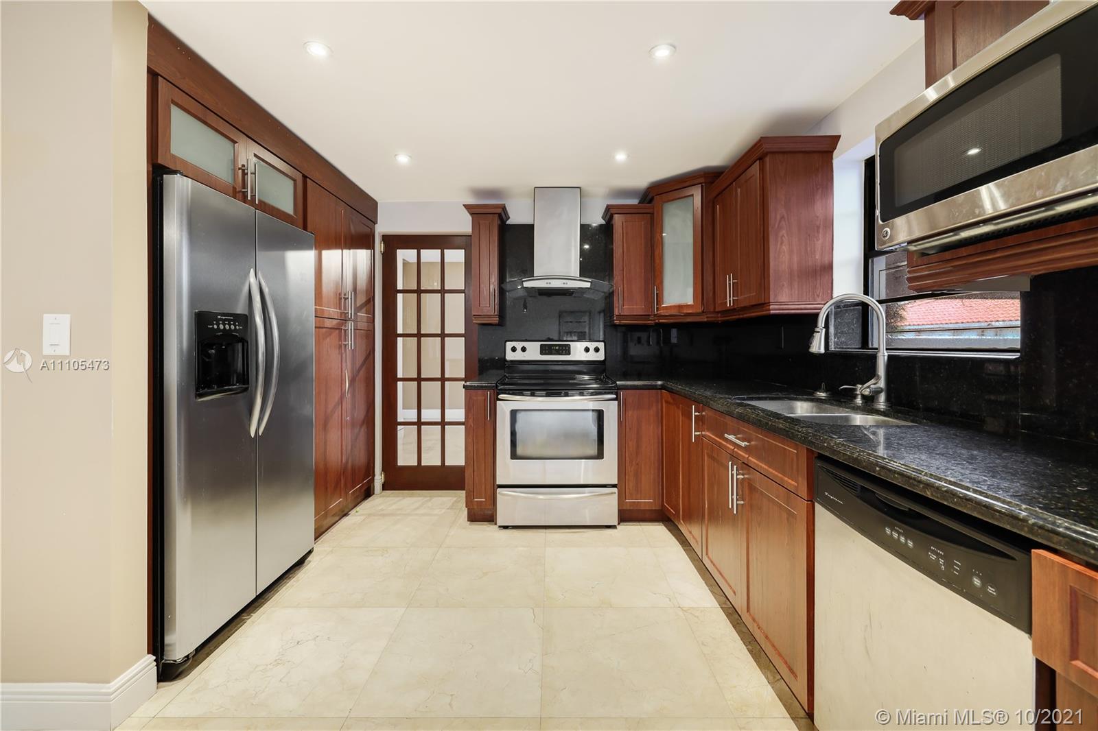 330 Southwest 133rd Place Miami, FL 33184 - Photo 14 of 51 a kitchen with stainless steel appliances granite countertop a refrigerator a stove and a sink