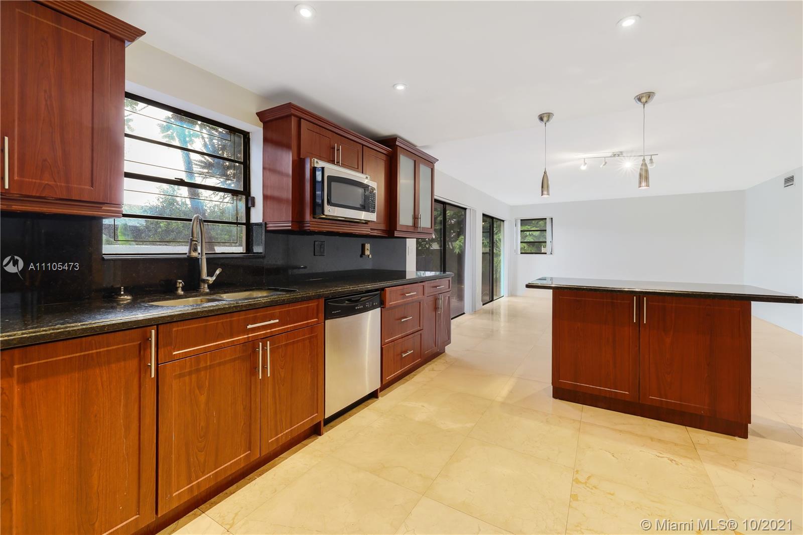 330 Southwest 133rd Place Miami, FL 33184 - Photo 15 of 51 a kitchen with stainless steel appliances granite countertop a sink and a stove
