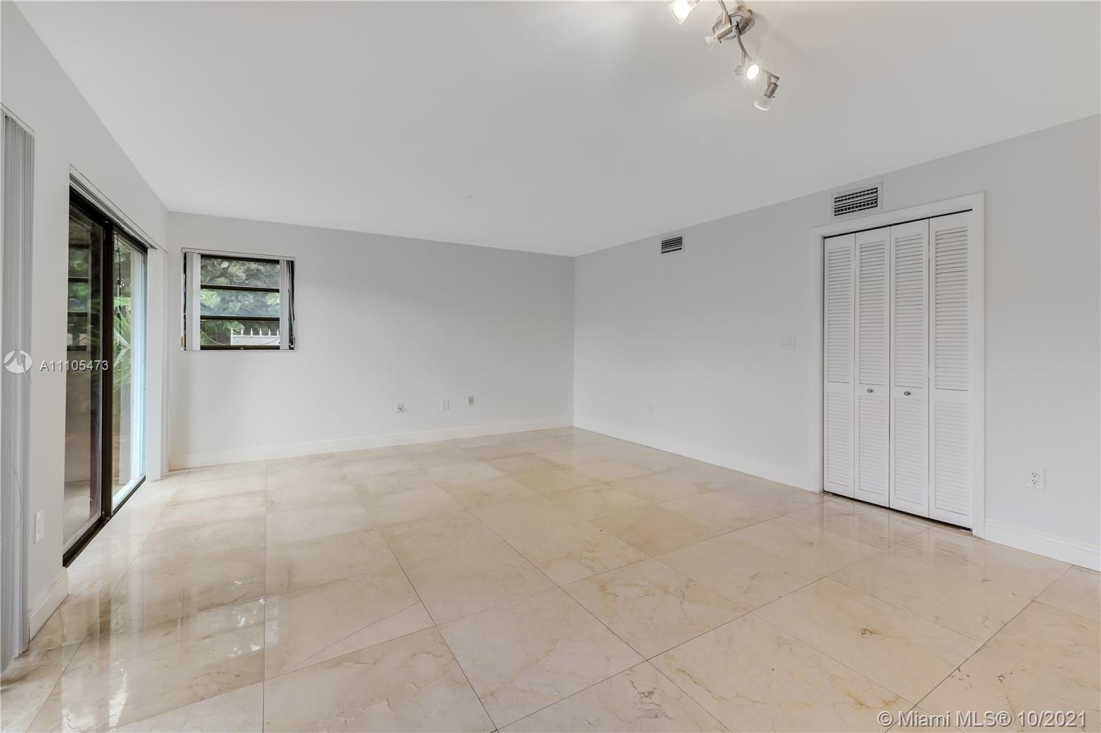 330 Southwest 133rd Place Miami, FL 33184 - Photo 16 of 51 an empty room with windows and chandelier fan