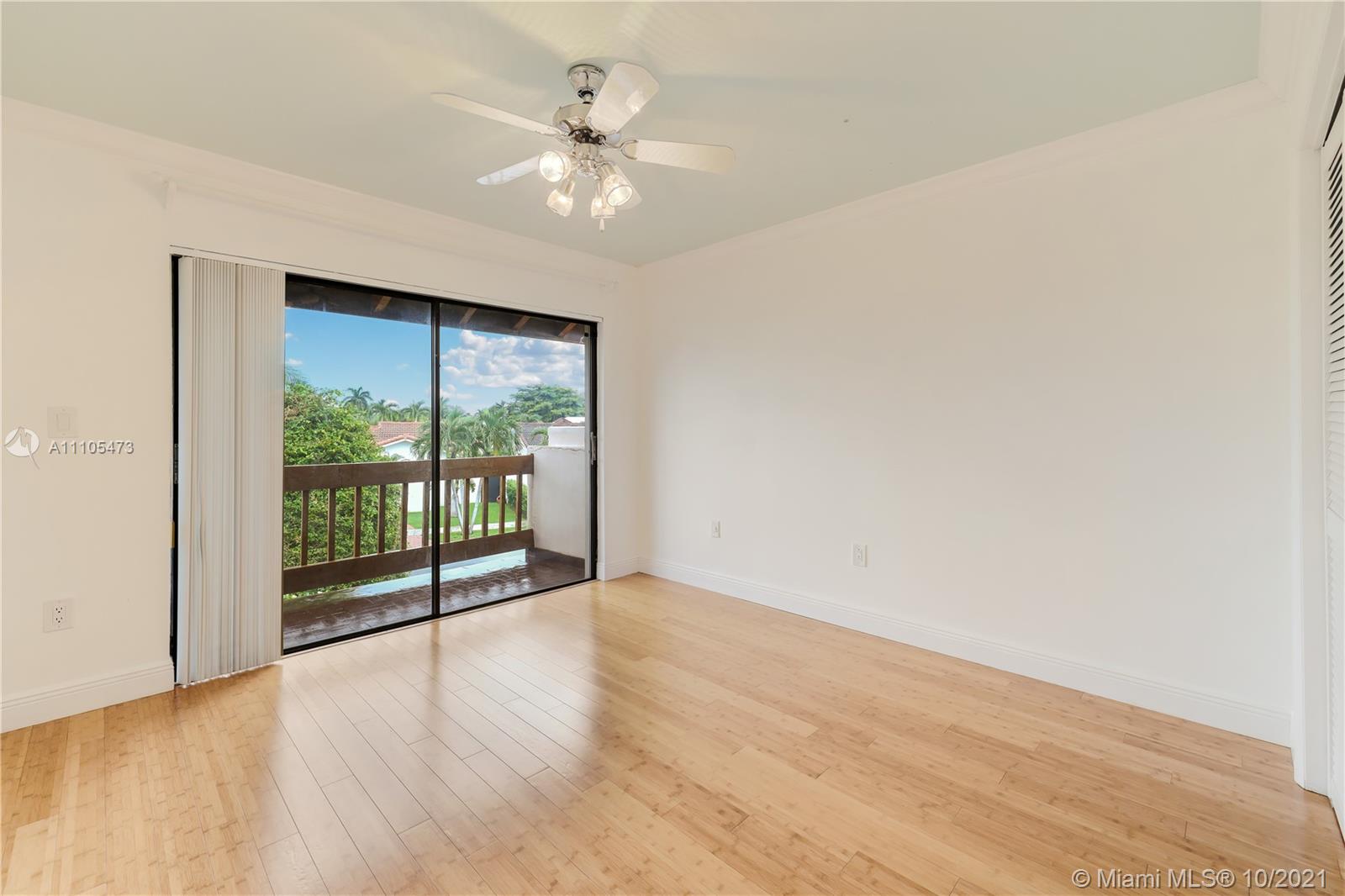 330 Southwest 133rd Place Miami, FL 33184 - Photo 34 of 51 an empty room with wooden floor and windows