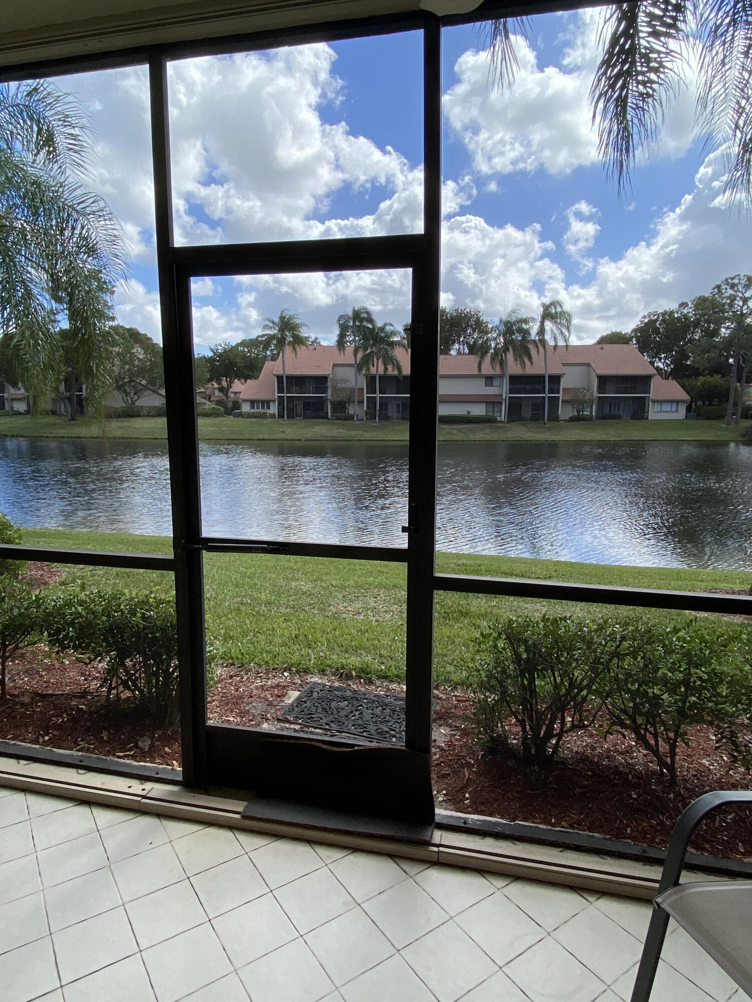 5621 Coach House Circle, Unit D Boca Raton, FL 33486 - Photo 26 of 29 a view of a back yard from a window