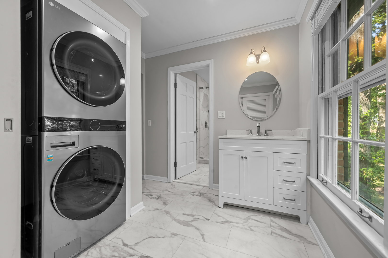 1010 South Green Bay Road Lake Forest, IL 60045 - Photo 16 of 25 a bathroom with a sink a mirror and a washer dryer