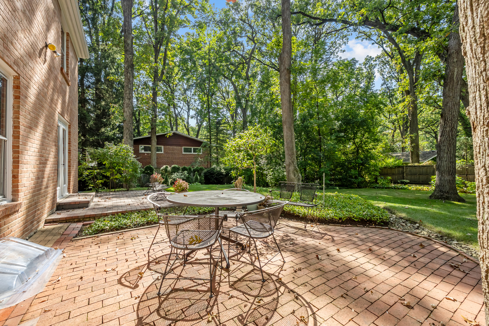 1010 South Green Bay Road Lake Forest, IL 60045 - Photo 23 of 25 a view of a chair and fire pit in the backyard with large trees