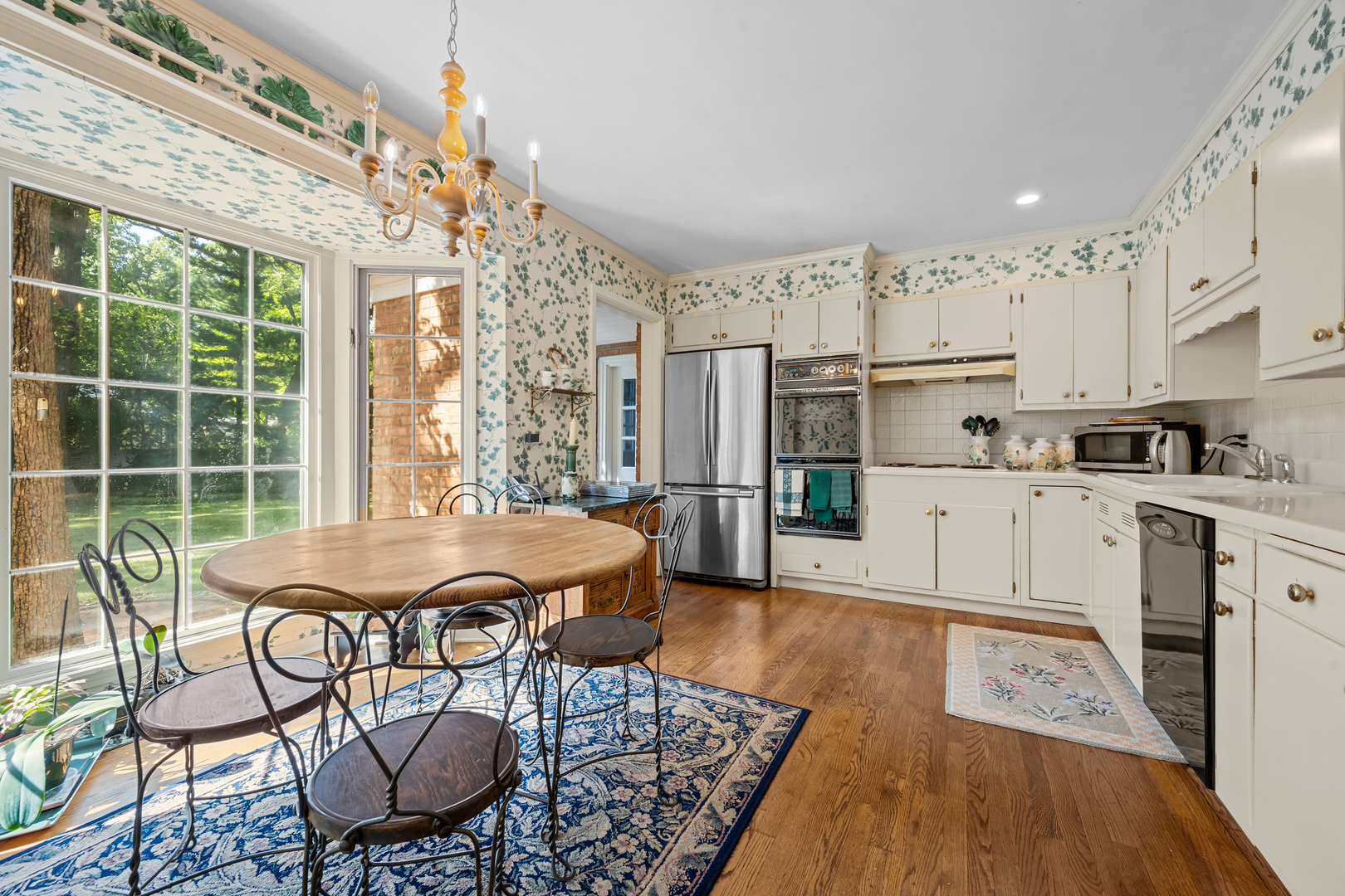 1010 South Green Bay Road Lake Forest, IL 60045 - Photo 8 of 25 a open kitchen with stainless steel appliances granite countertop a stove a refrigerator a dining table and chairs with wooden floor