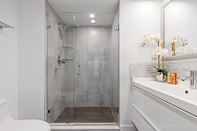 a bathroom with a shower sink and toilet