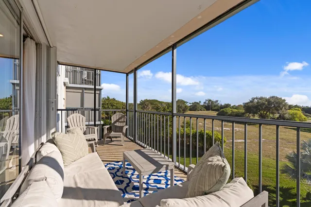 a balcony view with a large window and furniture
