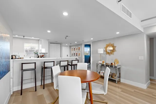 a view of kitchen with cabinets table and chairs