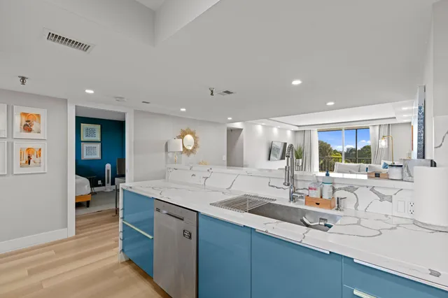 a large kitchen with a large counter top appliances and cabinets