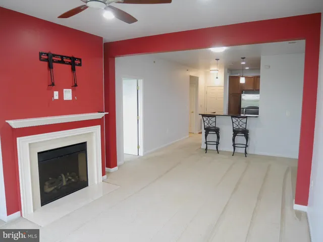 a view of an empty room with a fireplace