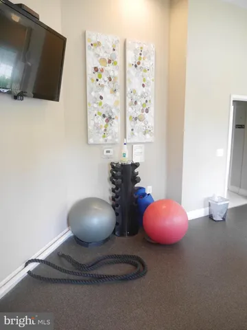 a view of a livingroom with workspace and a window