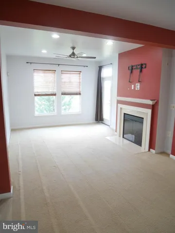 a kitchen with stainless steel appliances granite countertop a sink a stove a microwave a refrigerator and chairs