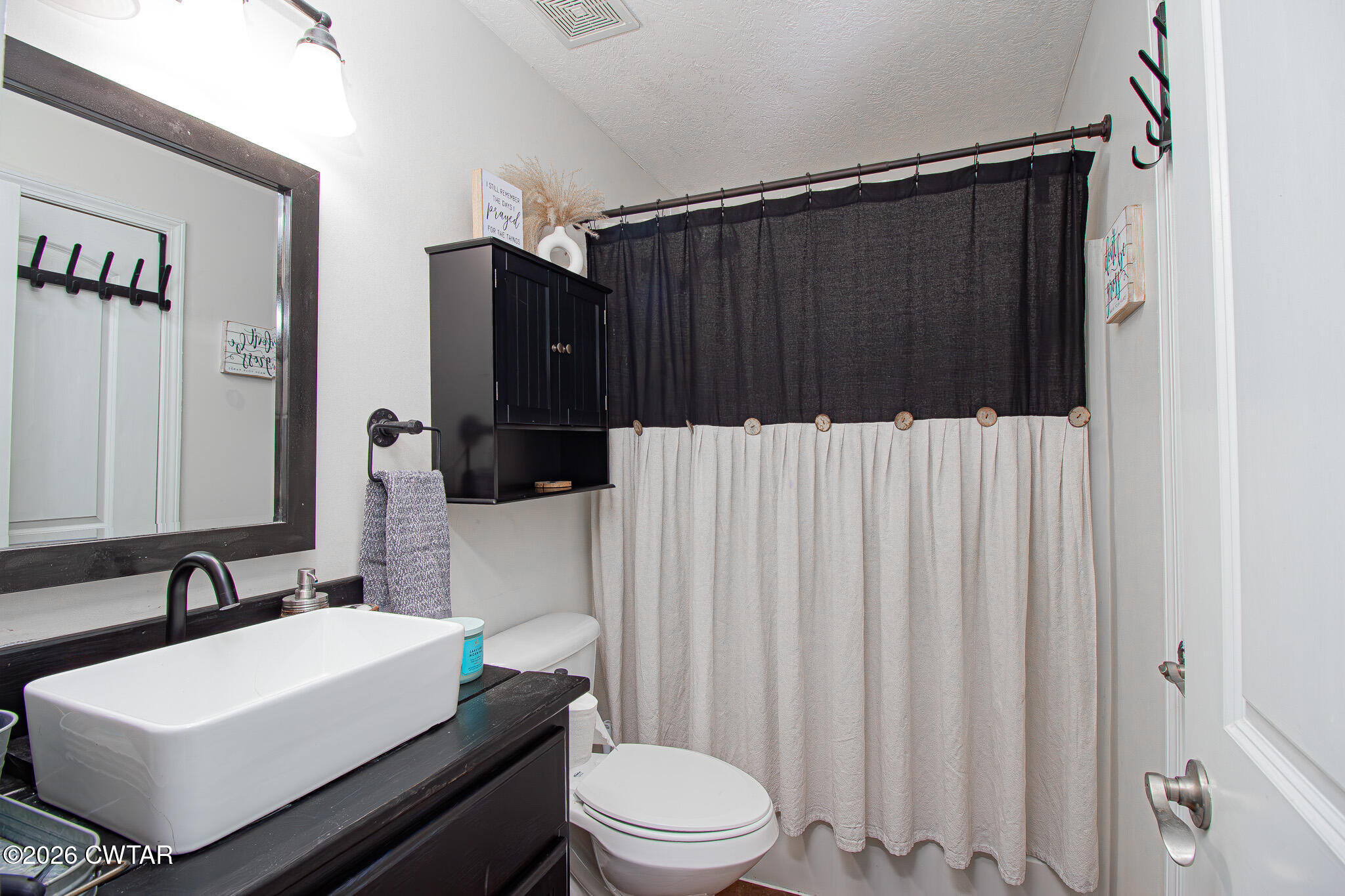 916 Landfill Road Brownsville, TN 38012 - Photo 11 of 21 a bathroom with a sink a toilet a shower and a mirror