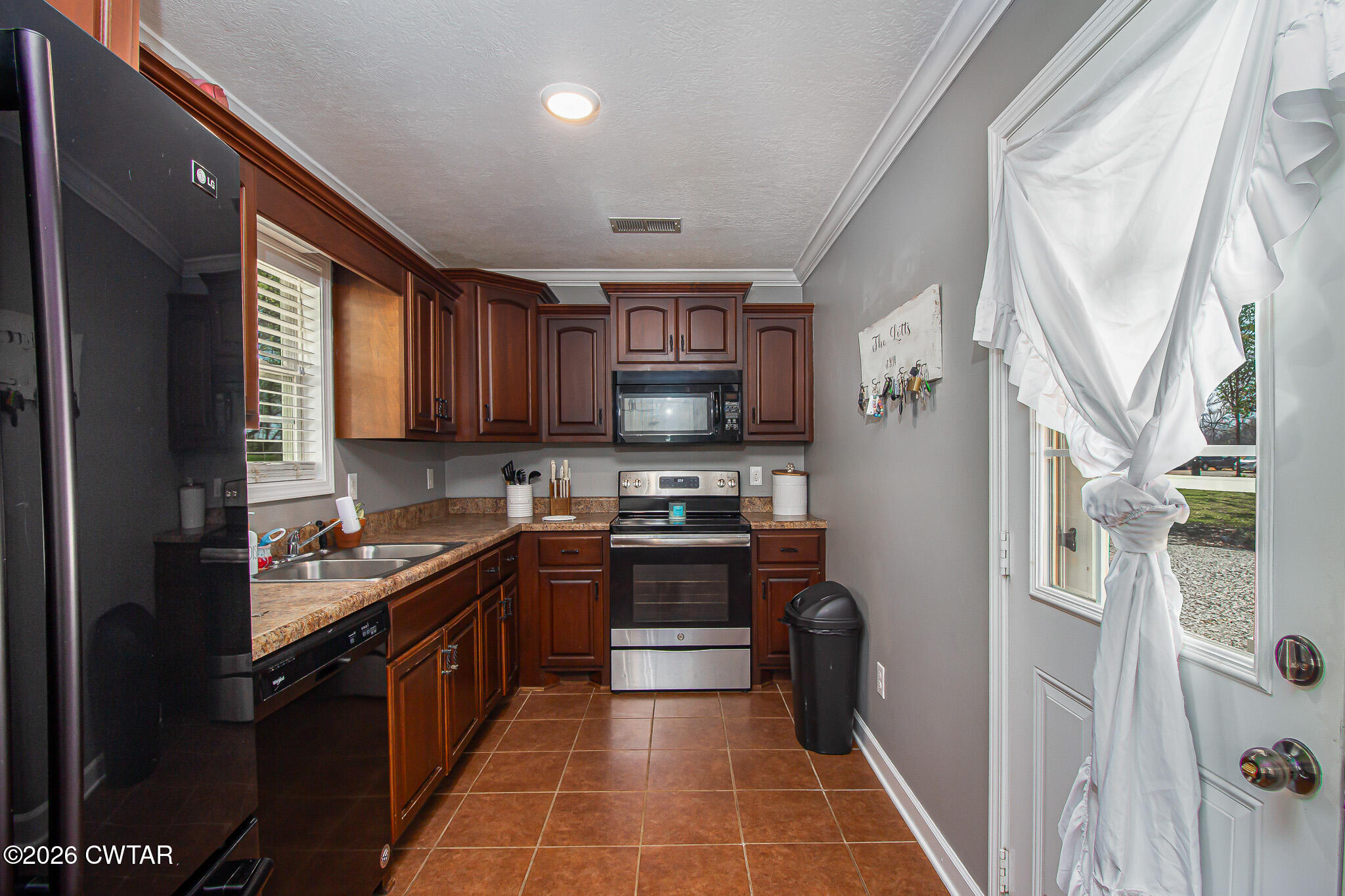 916 Landfill Road Brownsville, TN 38012 - Photo 8 of 21 a kitchen with stainless steel appliances granite countertop a stove sink and cabinets