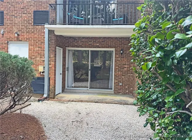 a view of a brick house with plants