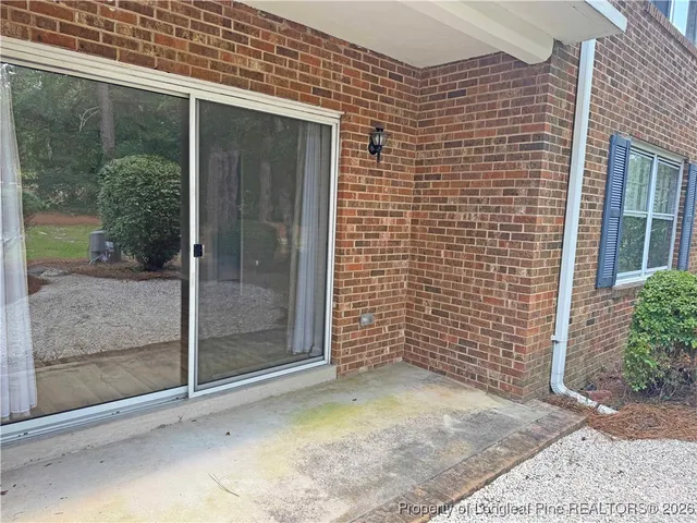 a view of a brick house with a large window