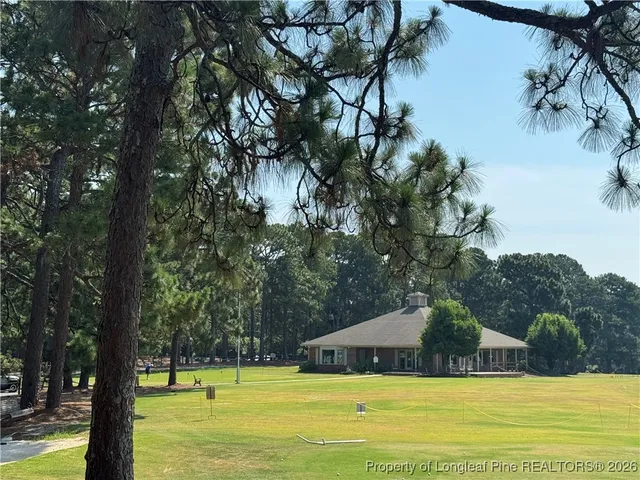 a view of a swimming pool with an outdoor seating and a forest
