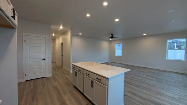 an empty room with wooden floor and entrance