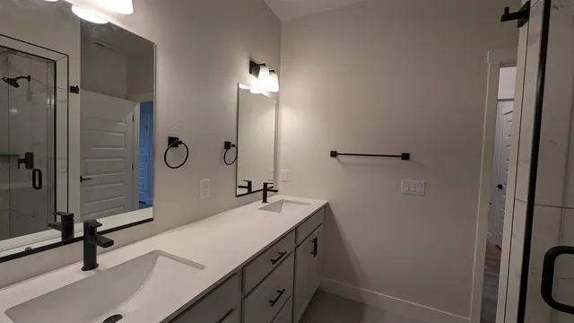 a bathroom with a sink a light fixture and a mirror