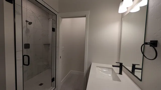 a bathroom with a shower and mirror