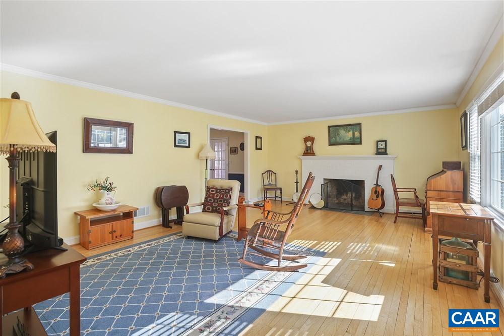 2807 Northfield Road Charlottesville, VA 22901 - Photo 6 of 35 a living room with furniture a rug and a fireplace