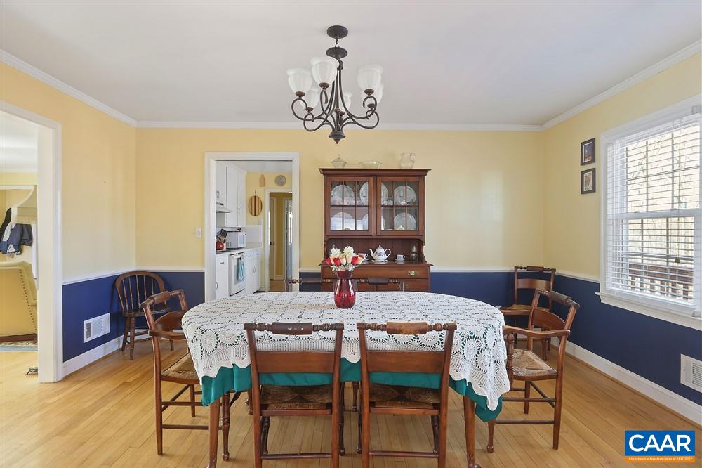 2807 Northfield Road Charlottesville, VA 22901 - Photo 10 of 35 a view of a dining room with furniture a chandelier and wooden floor