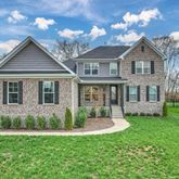 a front view of a house with a yard and porch