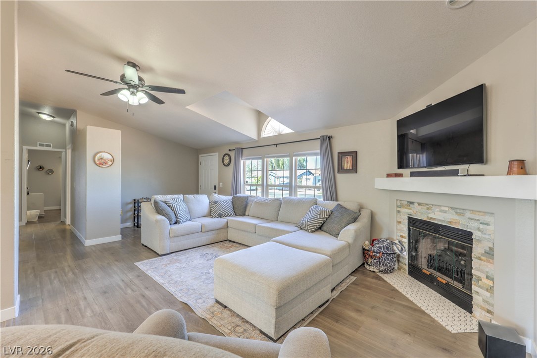 348 Tres Palomas Street Overton, NV 89040 - Photo 9 of 41 Vast living area with high vaulted ceilings and a captivating fireplace, perfect for relaxation.