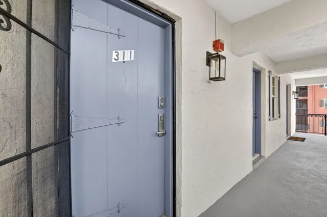 a view of a hallway with paintings on the wall