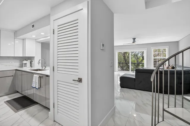 a kitchen with a refrigerator and white cabinets