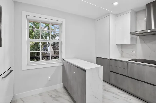 a view of a kitchen with wooden floor and electronic appliances