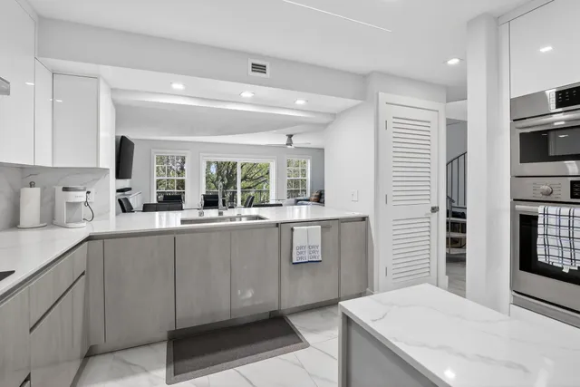 a kitchen with granite countertop cabinets and window