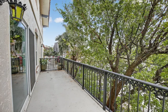 a view of a balcony with wooden floor and fence