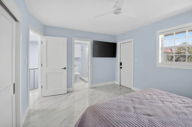 a view of a livingroom with wooden floor and a flat screen tv