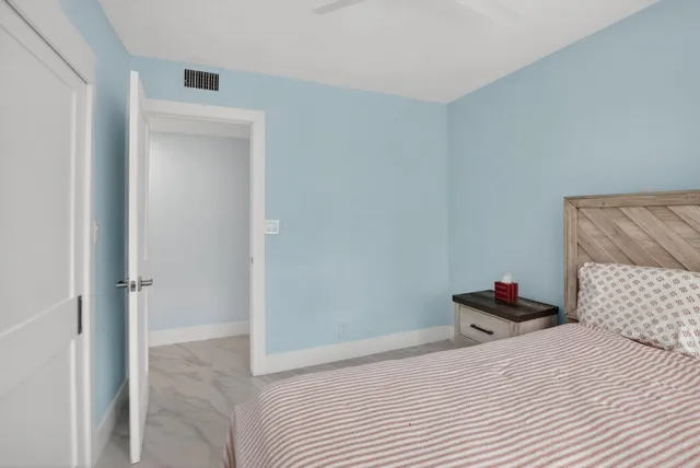 a bedroom with a bed and a wall painting
