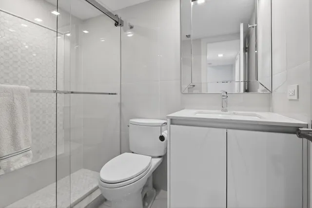 a bathroom with a sink toilet and shower