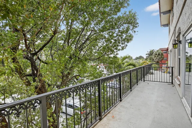 a view of a balcony with wooden fence and floor