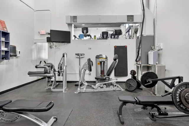 a view of a workspace with furniture and a flat screen tv