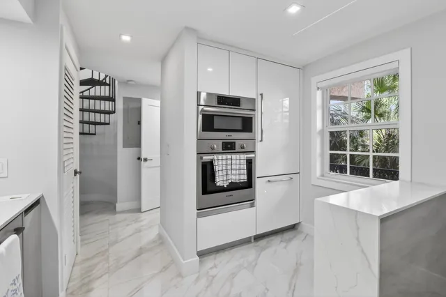 a view of kitchen with stainless steel appliances a refrigerator and a stove top oven