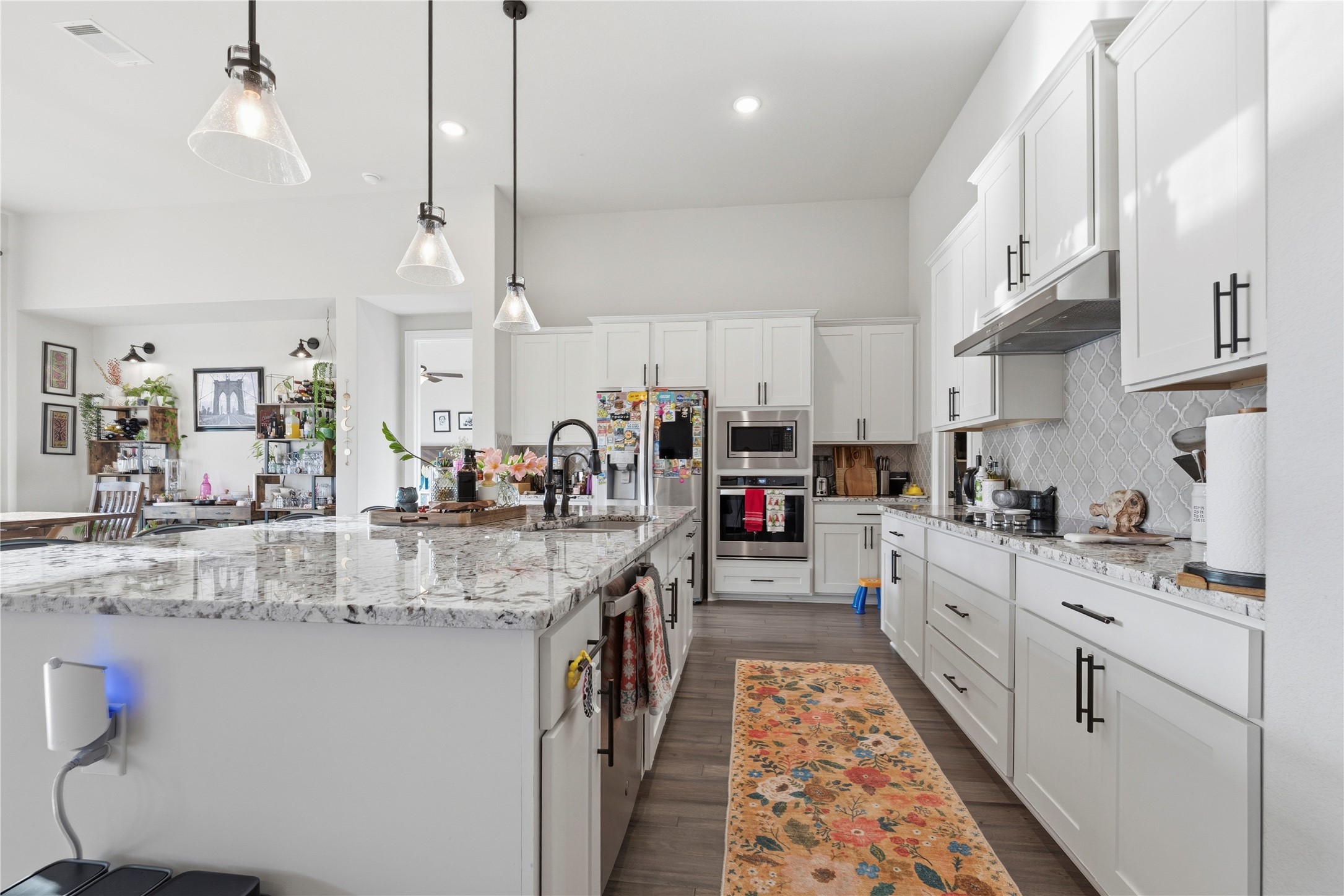 138 Rpd Spgs Cove Georgetown, TX 78628 - Photo 12 of 37 a kitchen with stainless steel appliances granite countertop a sink a stove and a refrigerator