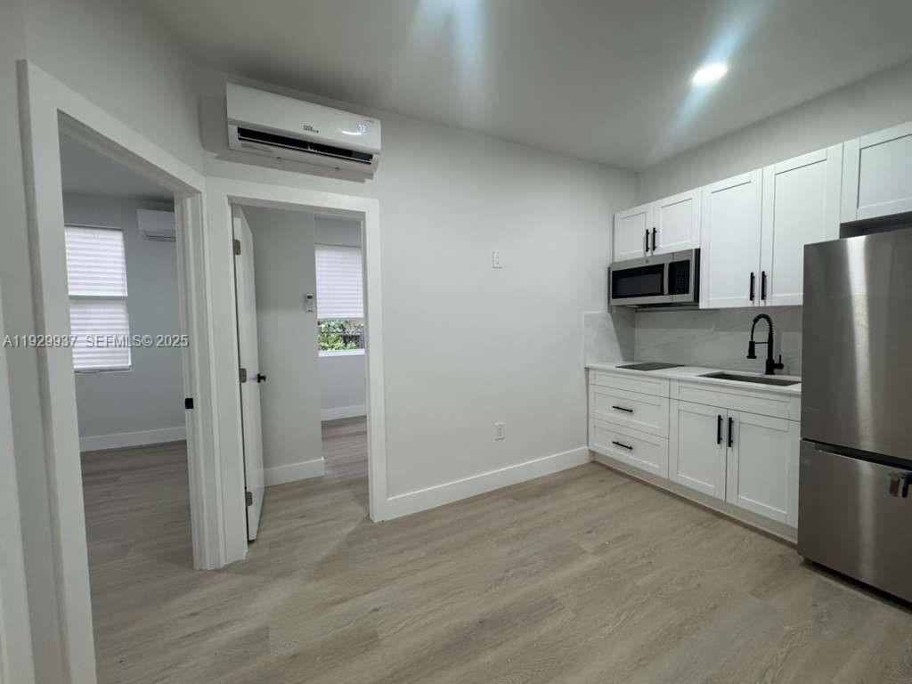 2425 Southwest 6th Street, Unit 16 Miami, FL 33135 - Photo 2 of 9 a kitchen with a refrigerator a stove and a sink