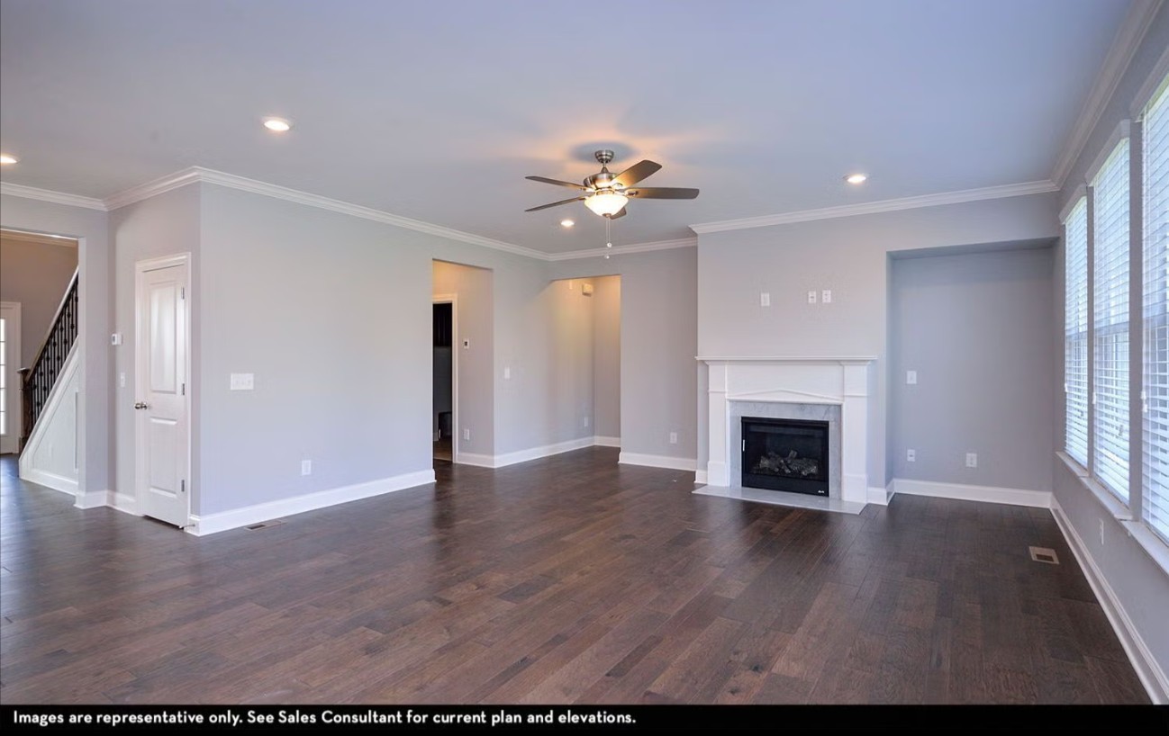 7925 Pine Street Fairview, TN 37062 - Photo 18 of 23 an empty room with wooden floor a ceiling fan and fireplace