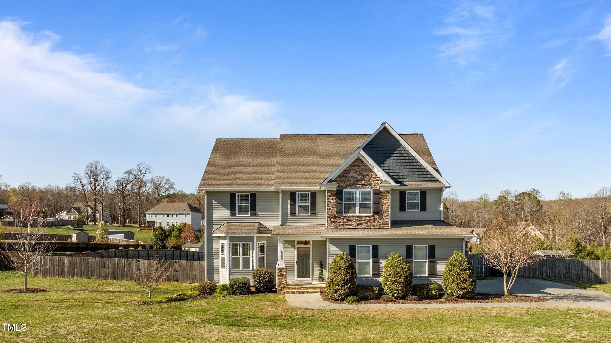 a front view of a house with a yard table and chairs