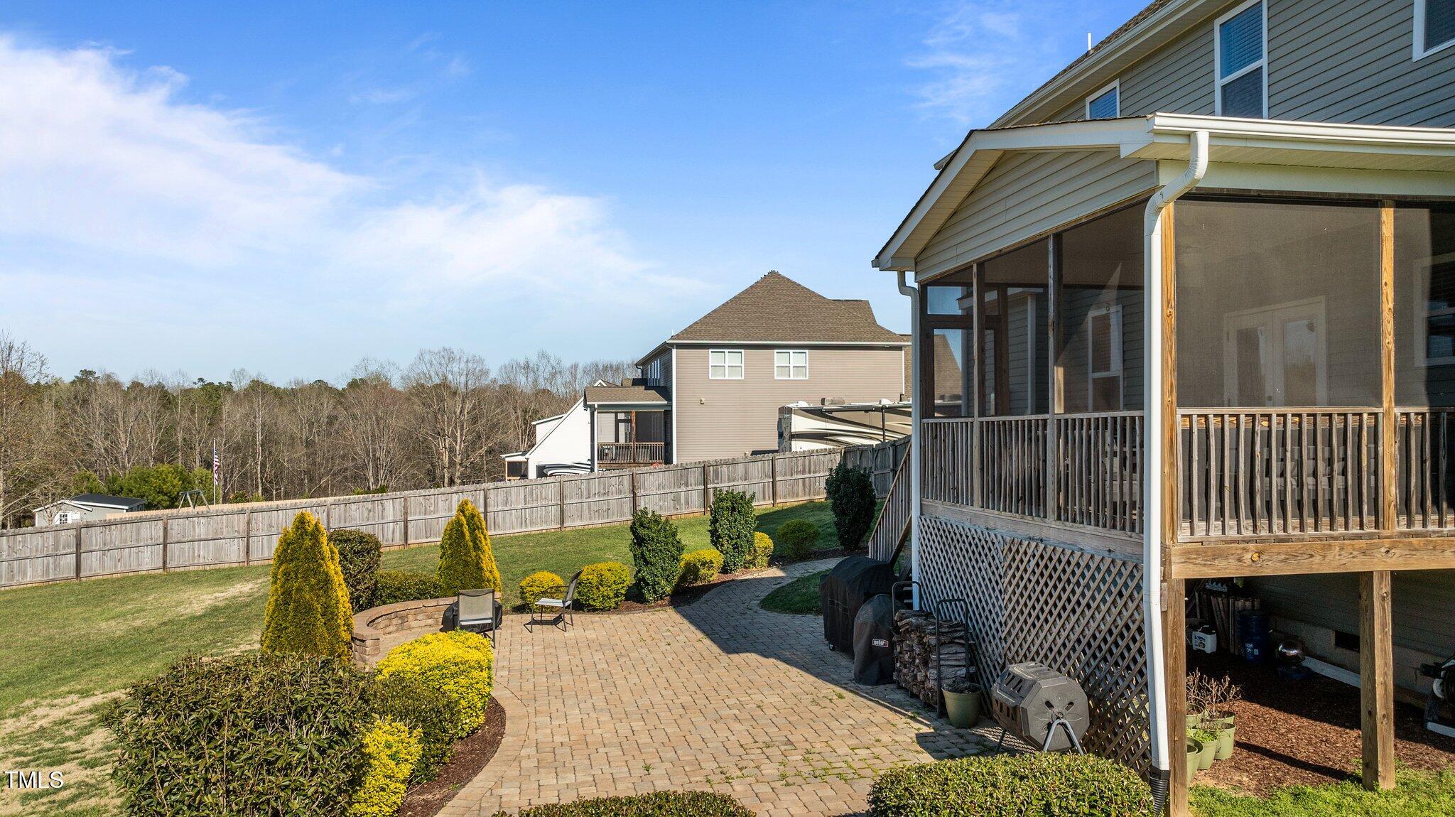 1036 Butterfly Circle Wake Forest, NC 27587 - Photo 12 of 51 a view of a house with backyard outdoor seating and a garden