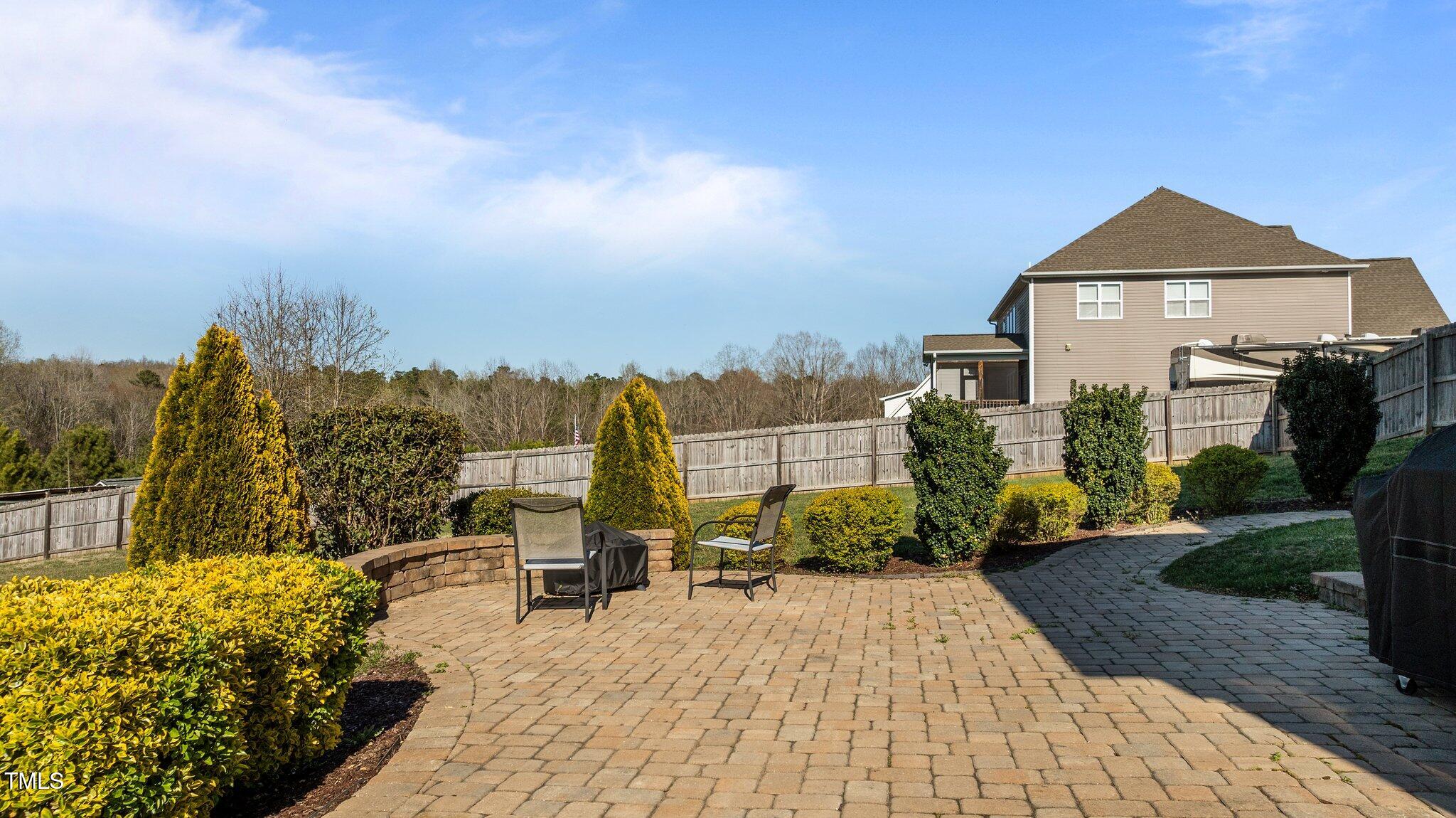 1036 Butterfly Circle Wake Forest, NC 27587 - Photo 13 of 51 a view of a house with many windows and trees in the background