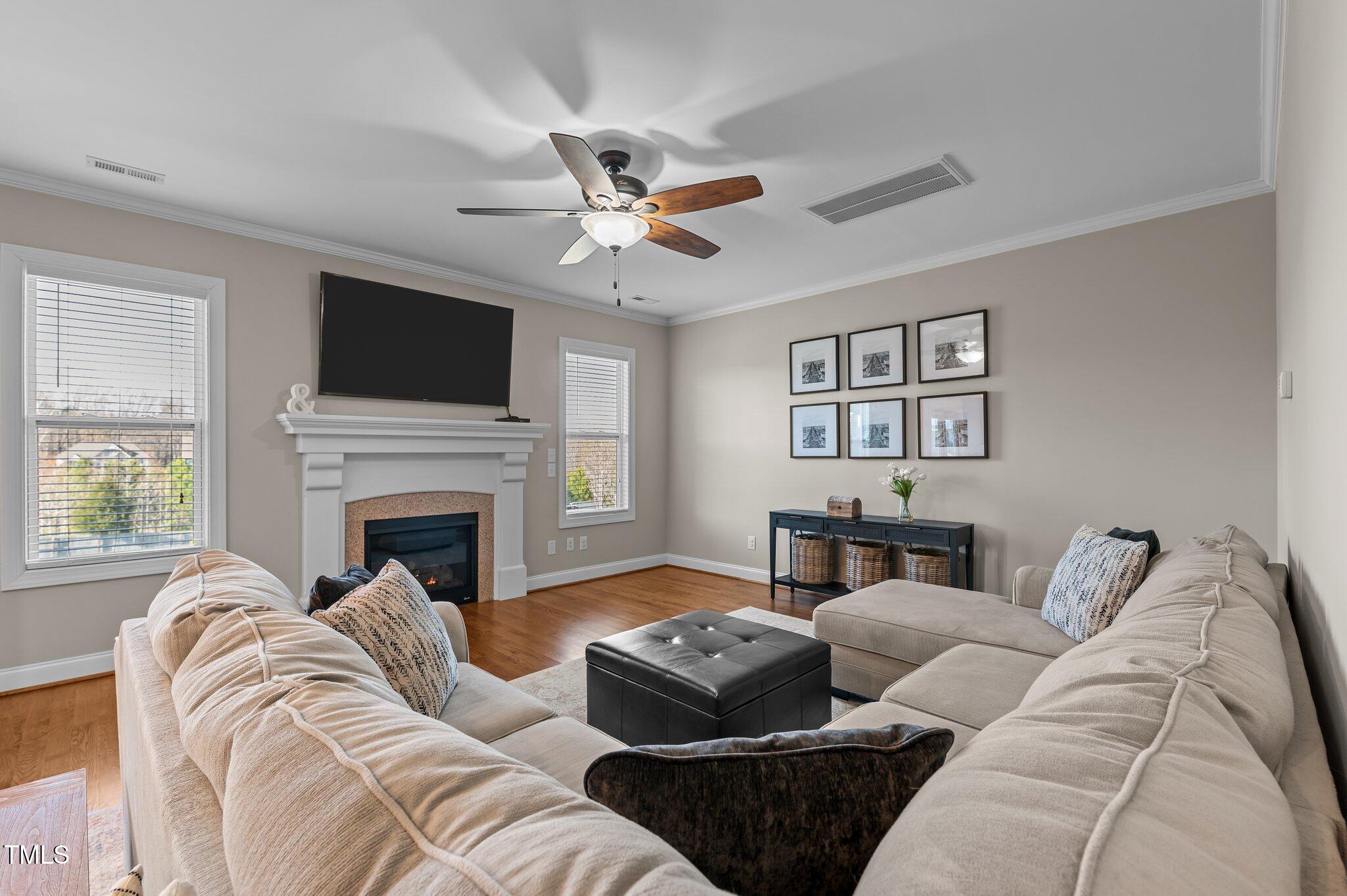 1036 Butterfly Circle Wake Forest, NC 27587 - Photo 27 of 51 a living room with furniture a flat screen tv and a fireplace