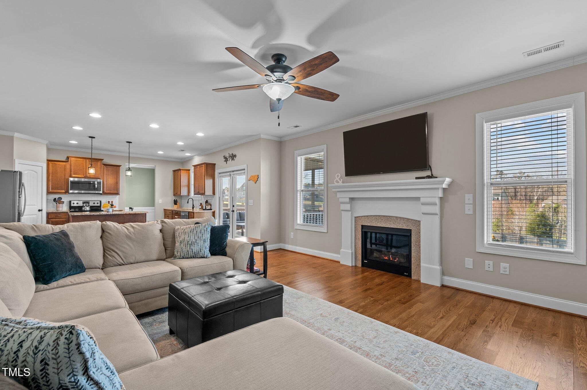 1036 Butterfly Circle Wake Forest, NC 27587 - Photo 29 of 51 a living room with furniture a fireplace and a flat screen tv
