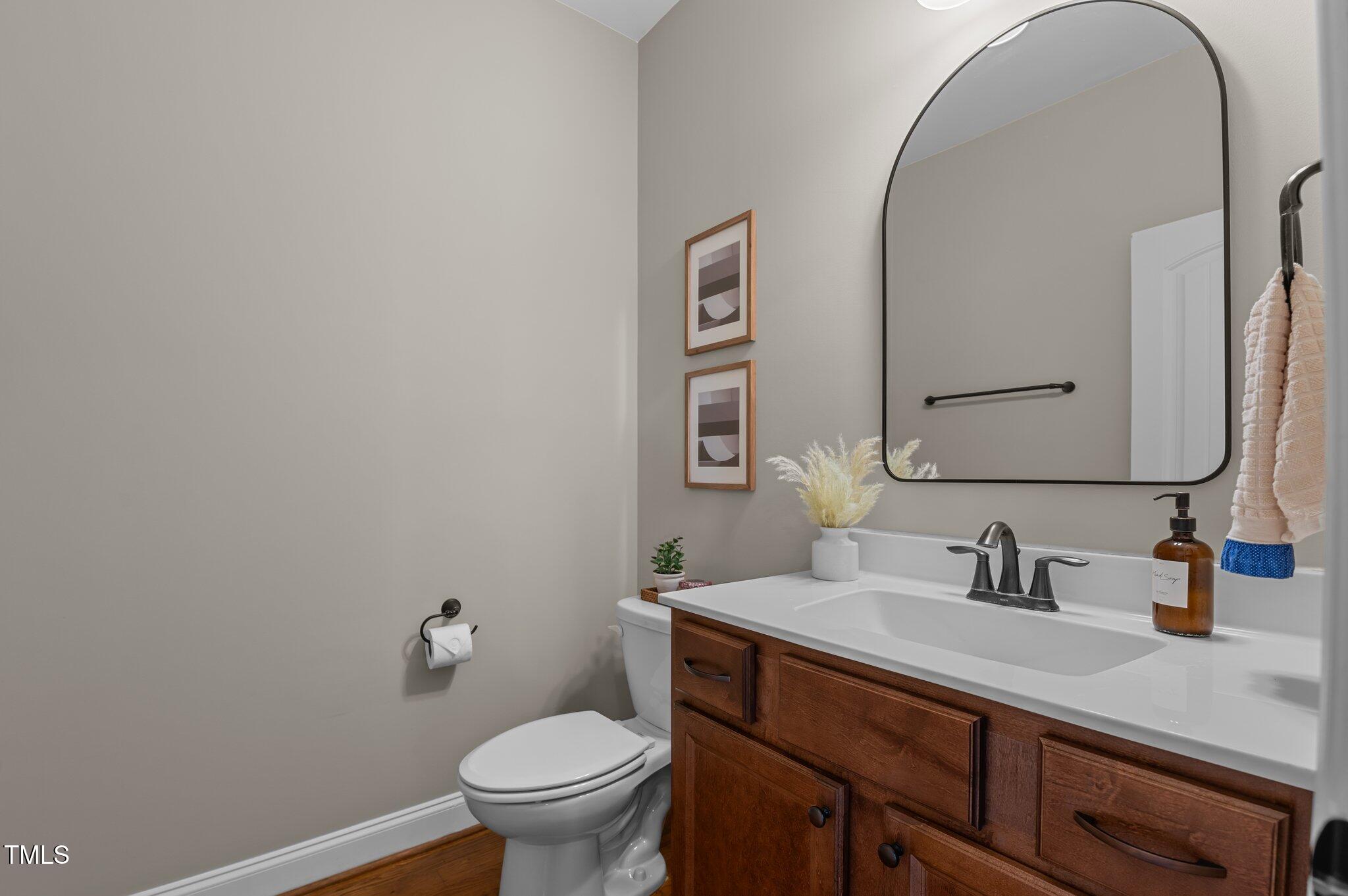 1036 Butterfly Circle Wake Forest, NC 27587 - Photo 30 of 51 a bathroom with a granite countertop toilet sink and mirror
