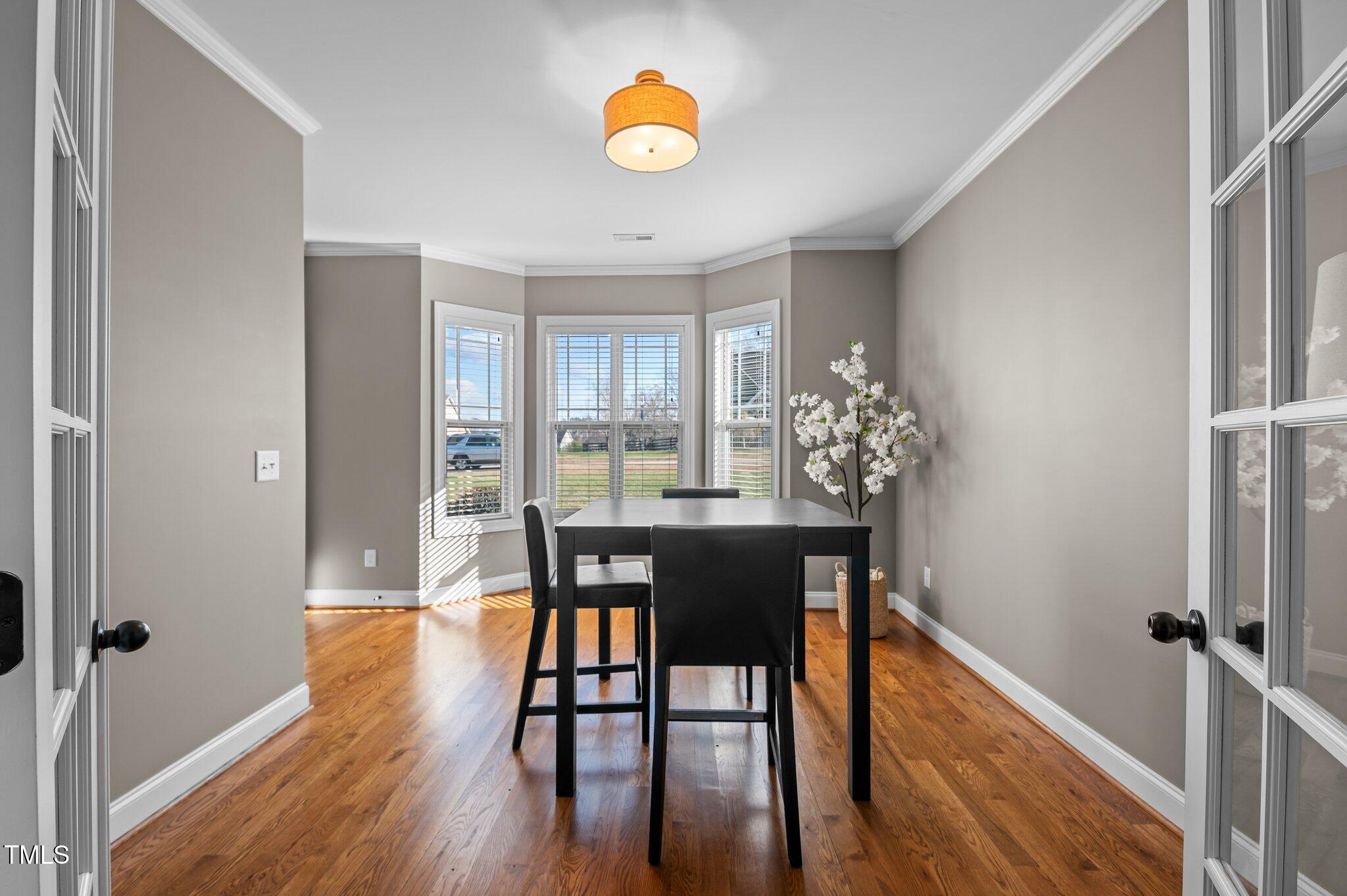 1036 Butterfly Circle Wake Forest, NC 27587 - Photo 34 of 51 a view of a dining room with furniture and wooden floor