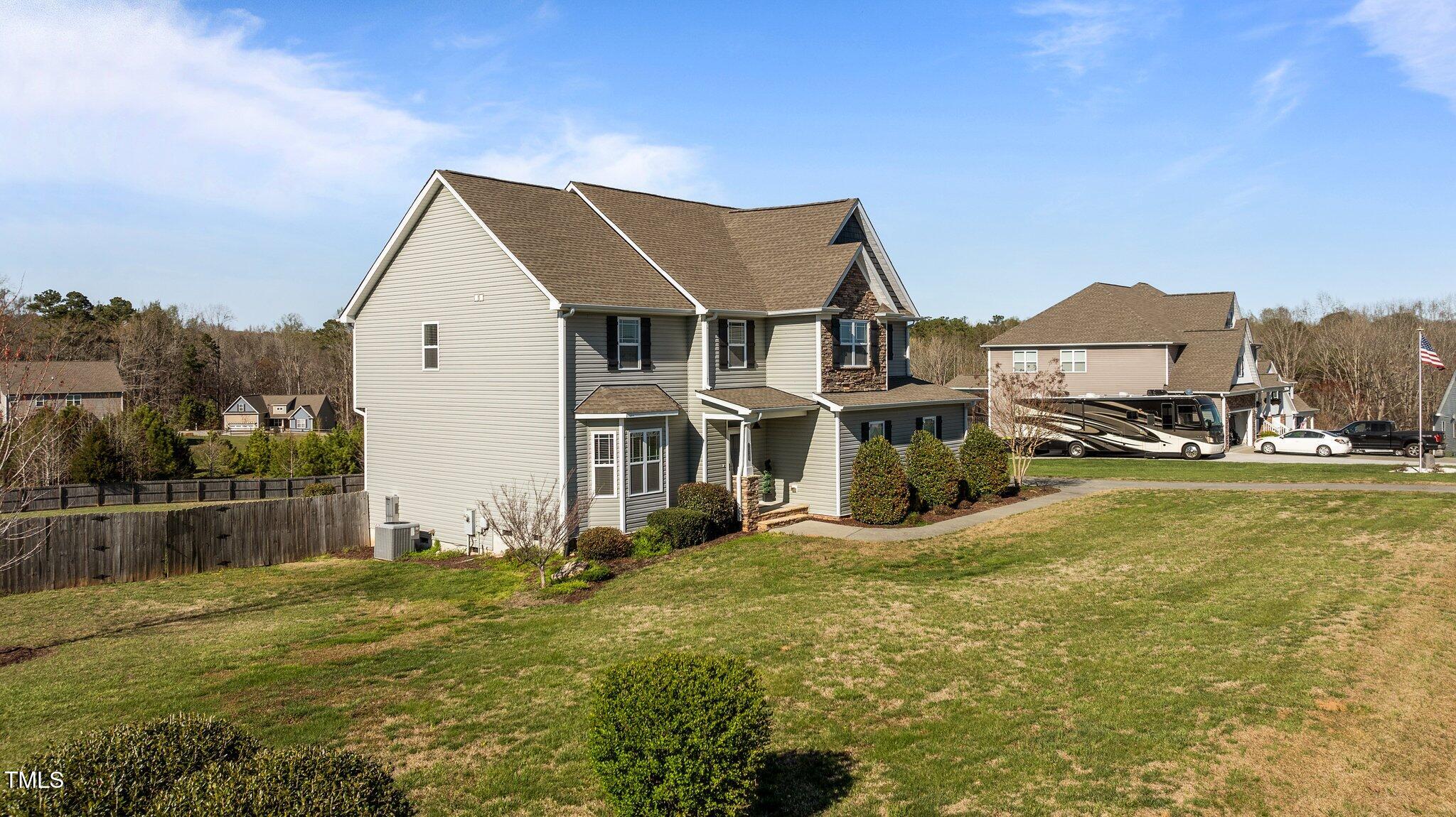 1036 Butterfly Circle Wake Forest, NC 27587 - Photo 3 of 51 a view of a big house with a big yard and large trees