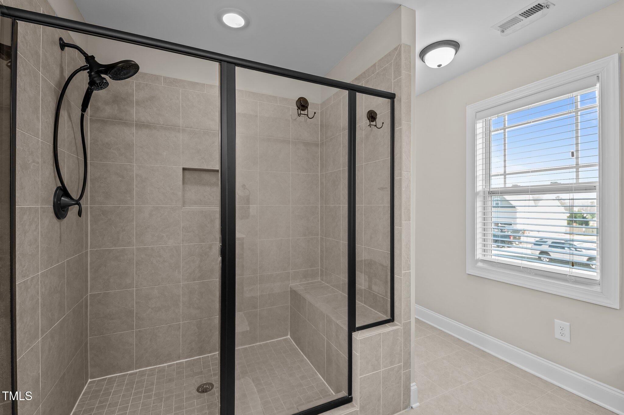 1036 Butterfly Circle Wake Forest, NC 27587 - Photo 42 of 51 a bathroom with a shower and a mirror